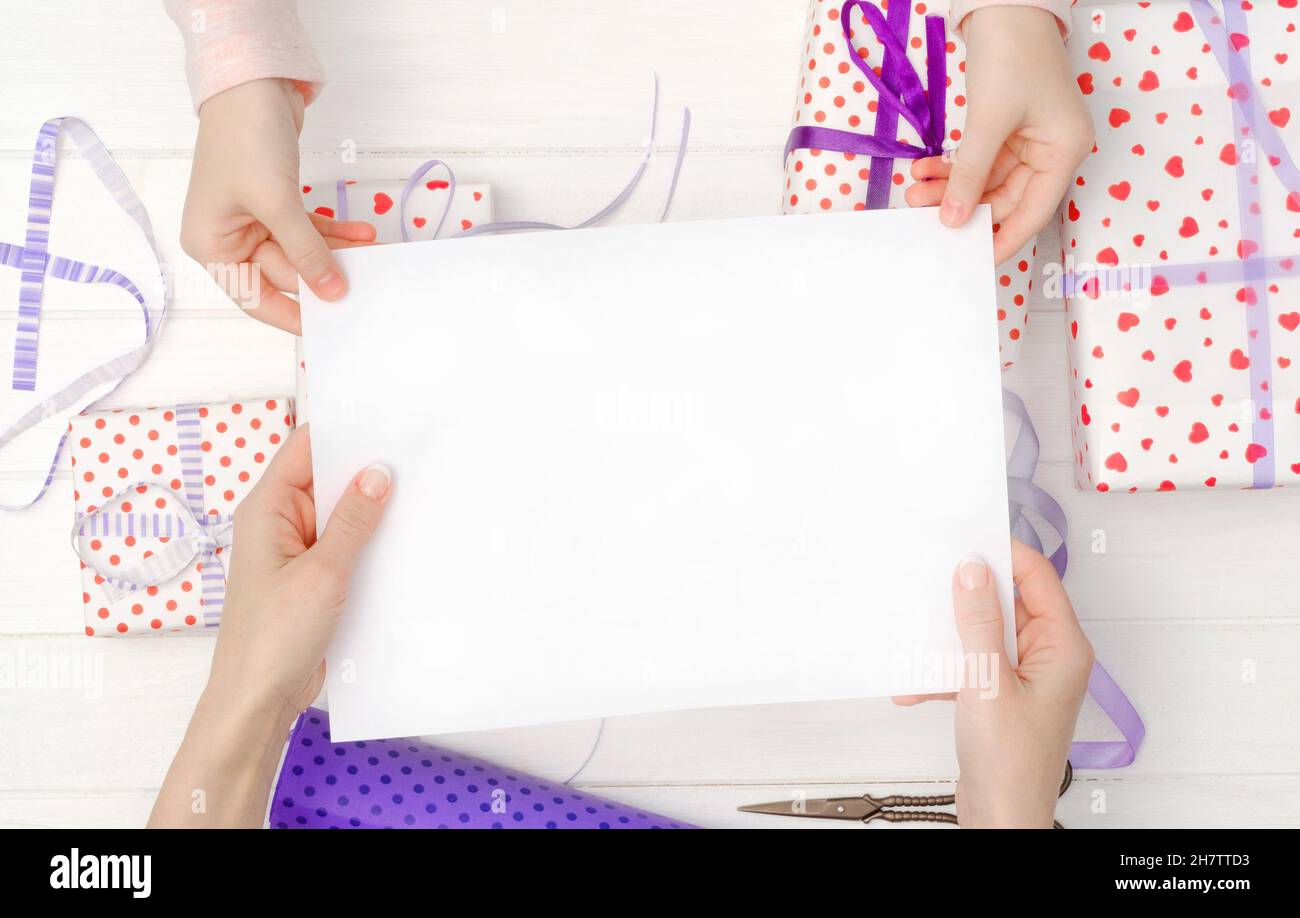 Empty blank sheet of paper in hands Stock Photo