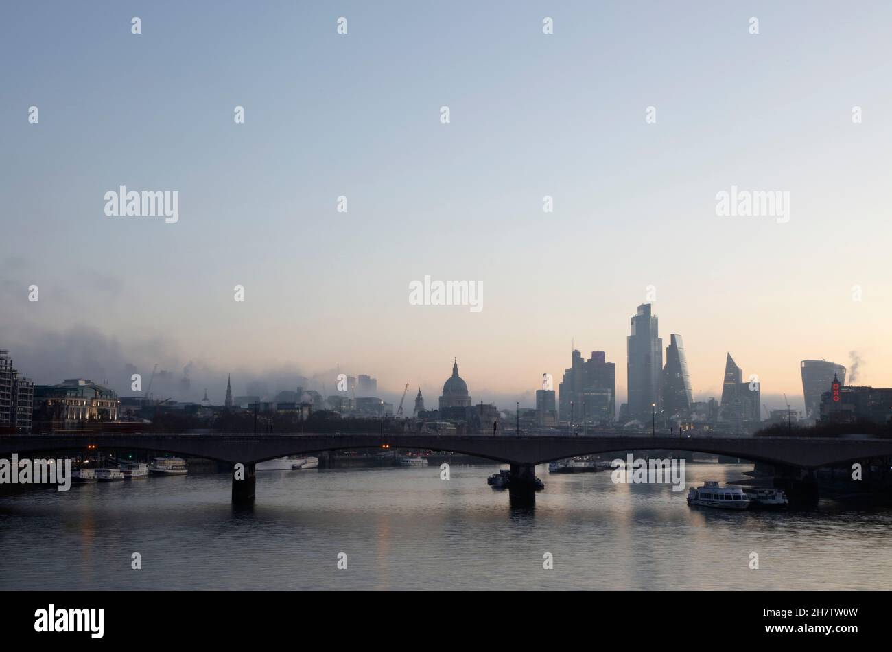 Dawn view looking downstream along the River Thames to Waterloo Bridge to St Paul’s Cathedral and the City of London skyline, London, UK Stock Photo