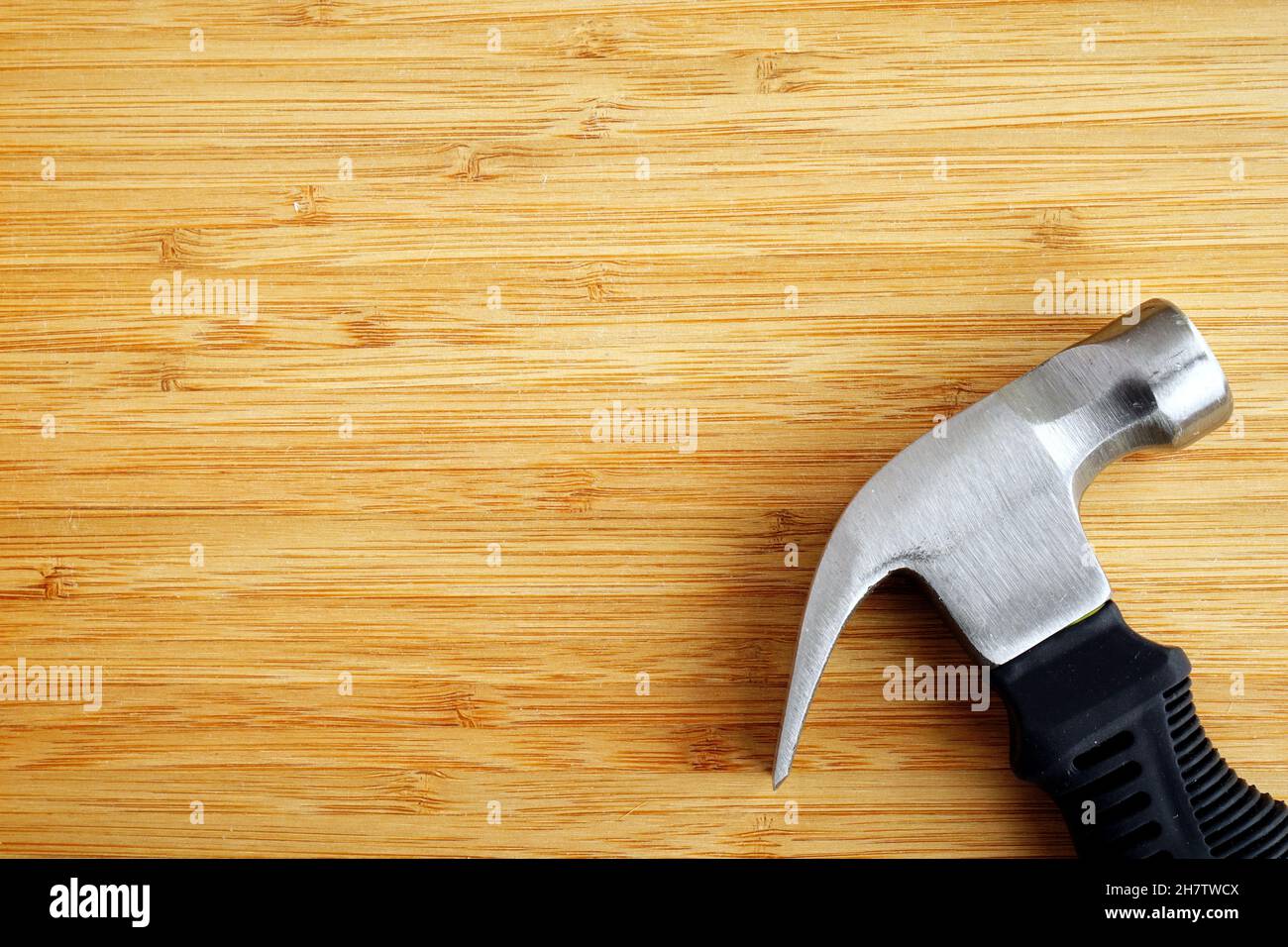 Stubby claw hammer on wooden background with copy space Stock Photo