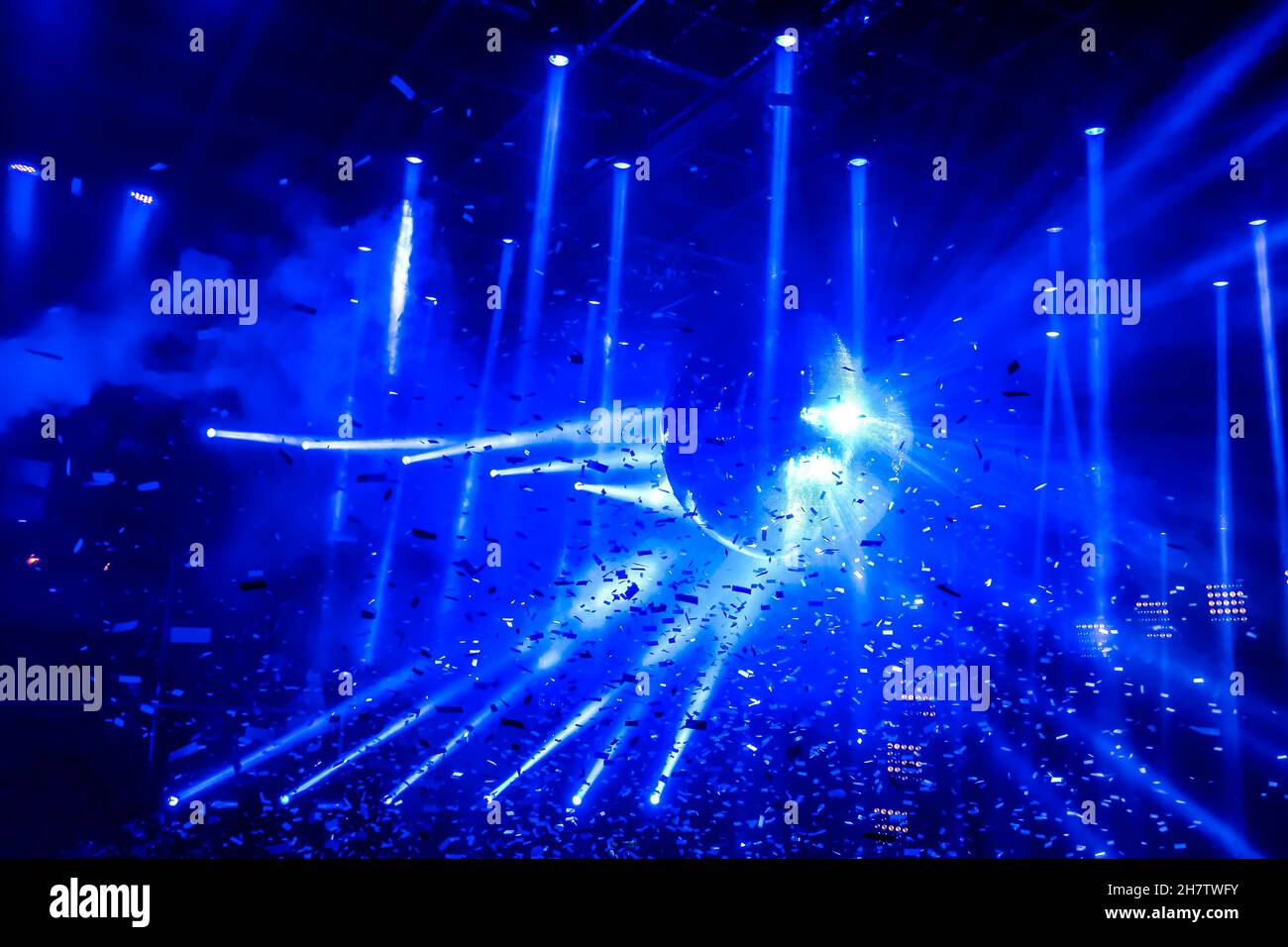 Laser show at generic party night club with bright spotlight on disco