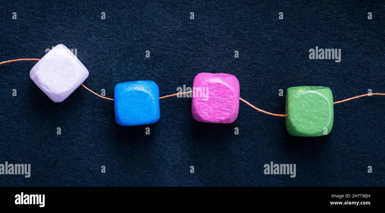 Wooden cube beads on thread Stock Photo