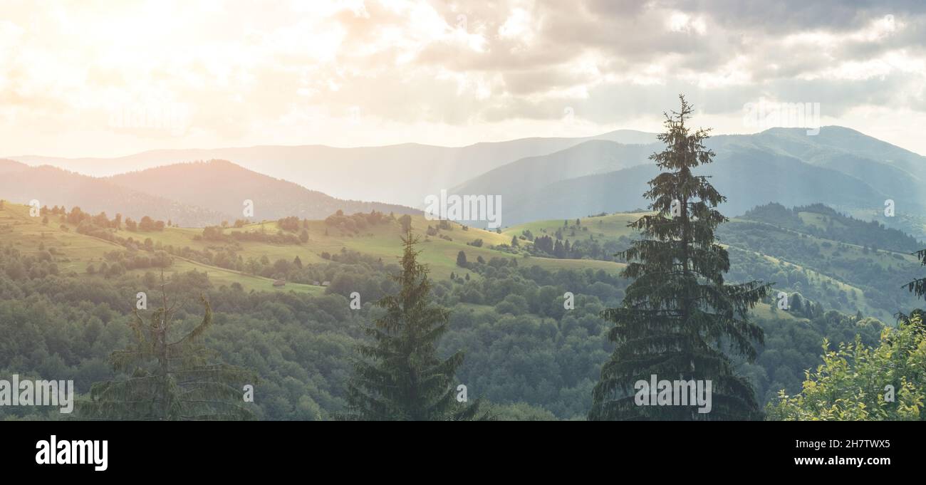 Panoramic view of mountains under cloudy sky Stock Photo