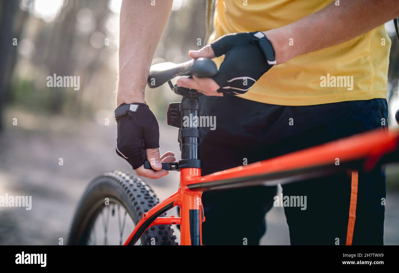 Rider adjusting seat height on bicycle Stock Photo Alamy