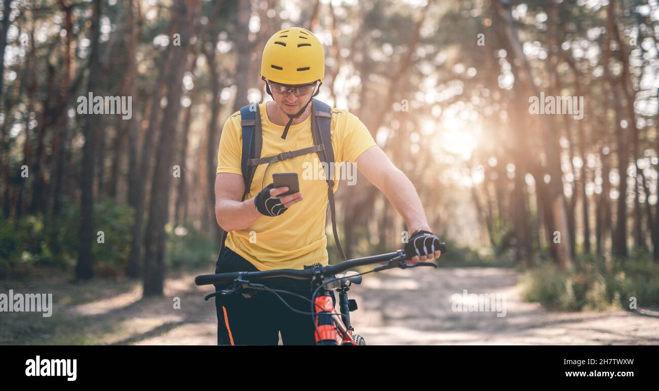 Cyclist checking route on smartphone Stock Photo