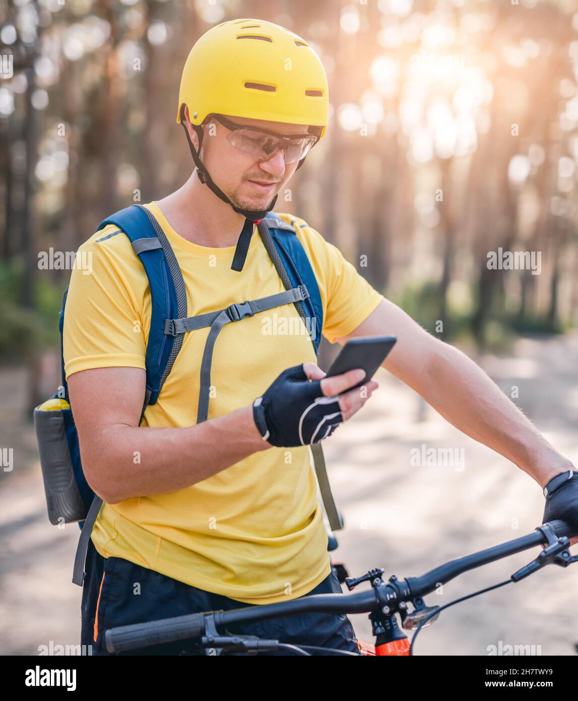 Man using smartphone with map during cycling Stock Photo