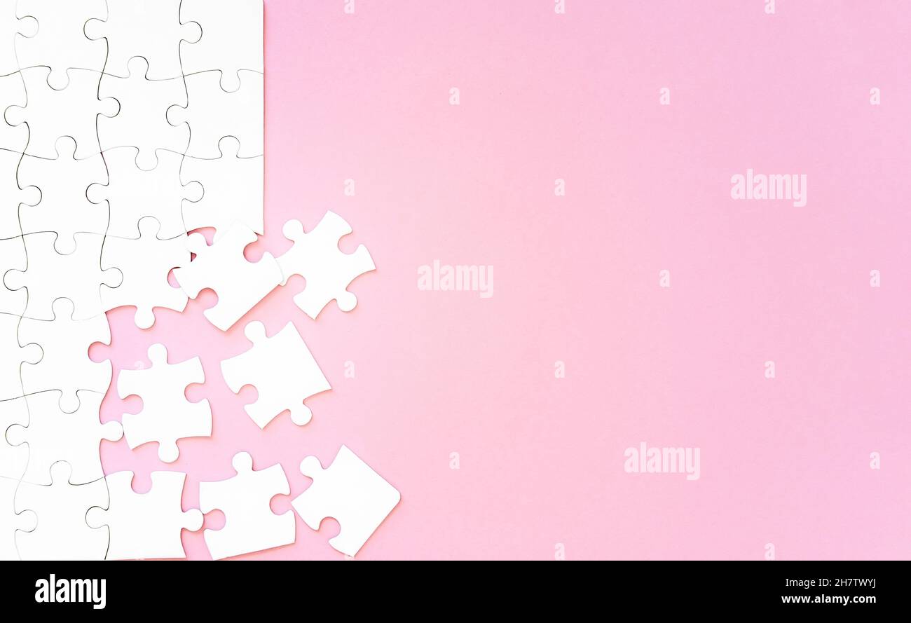Puzzle pieces on pink background Stock Photo