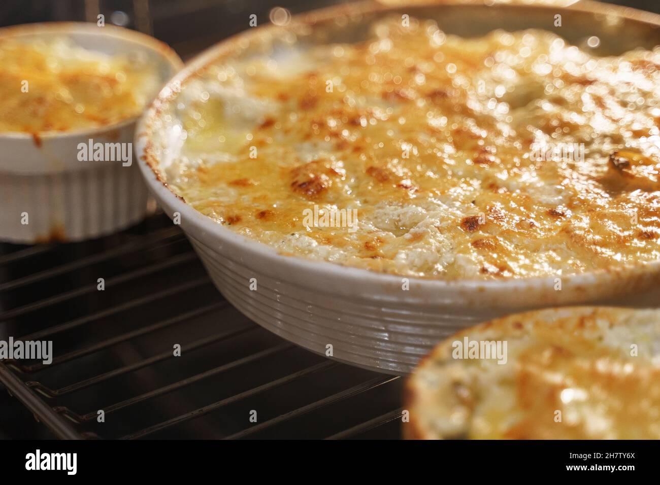 Homemade creamy Au Gratin Potatoes in oven Stock Photo Alamy