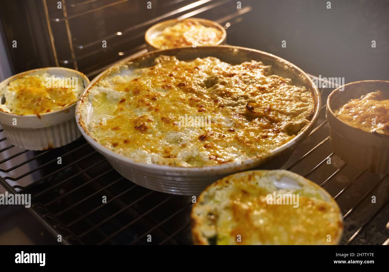 Homemade creamy Au Gratin Potatoes in oven Stock Photo Alamy