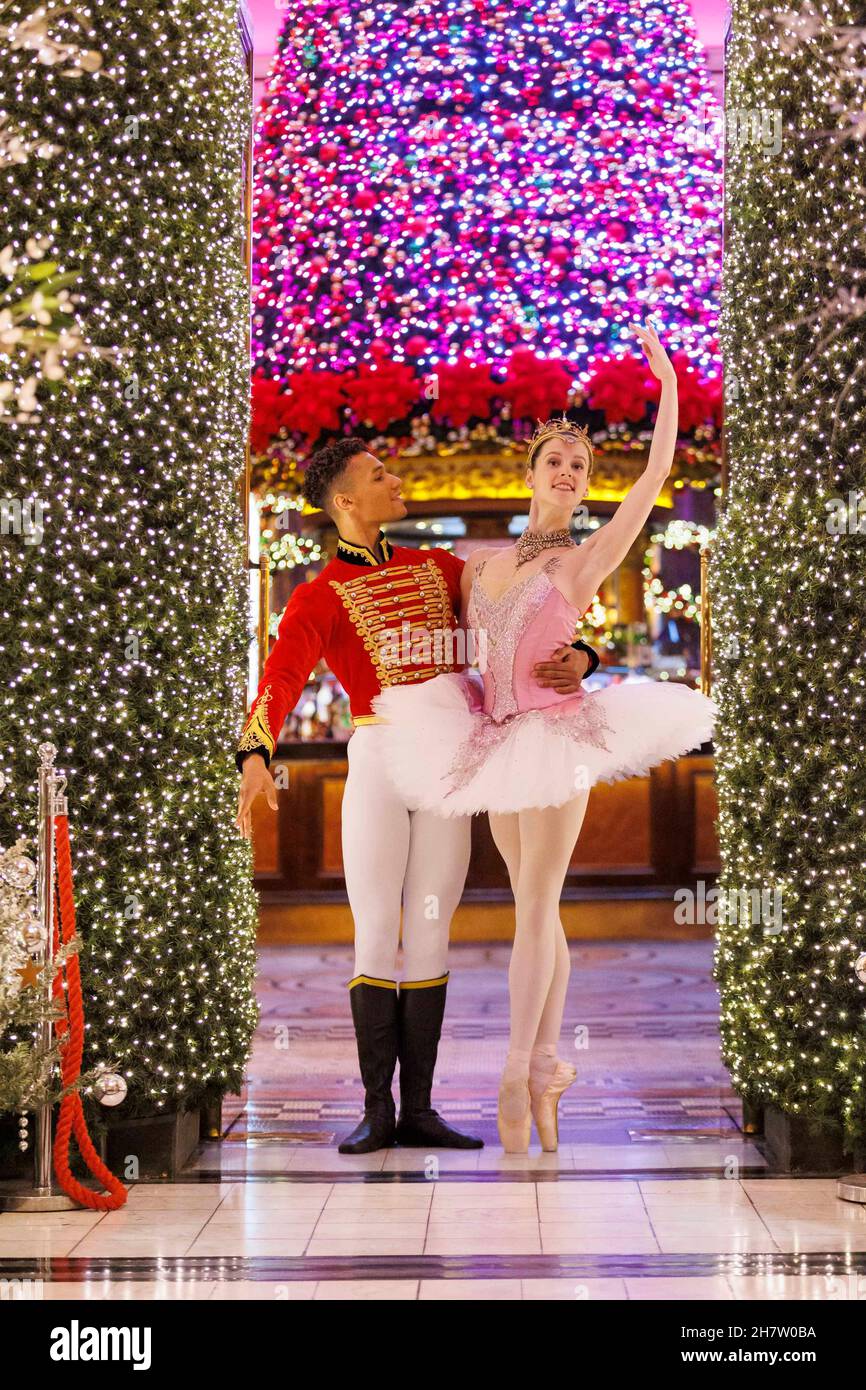 Edinburgh, United Kingdom. 25 November, 2021 Pictured: Scottish Ballet dancers Roseanna Leney as The Sugarplum Fairy, Jerome Barnes as The Nutcracker Prince and Javier Andreu as The Rat King posing in The Dome bar Edinburgh, underneath their famous Christmas tree. The Nutcracker runs at Festival Theatre Edinburgh 1-31 December, before touring to Glasgow, Aberdeen, Inverness, Newcastle and Belfast. Credit: Rich Dyson/Alamy Live News Stock Photo