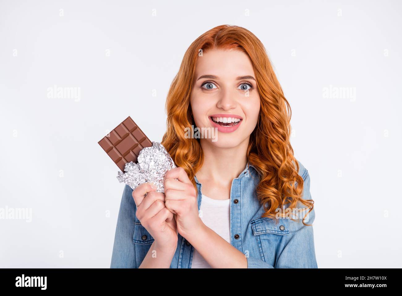 Photo of charming amazed pretty hungry woman hold chocolate unhealthy food isolated on grey color background Stock Photo