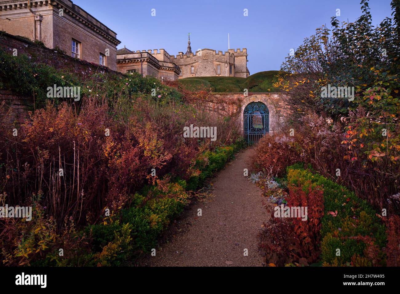 Gate entrance and formal gardens in early autumn light at Rousham House, Oxfordshire,England Stock Photo