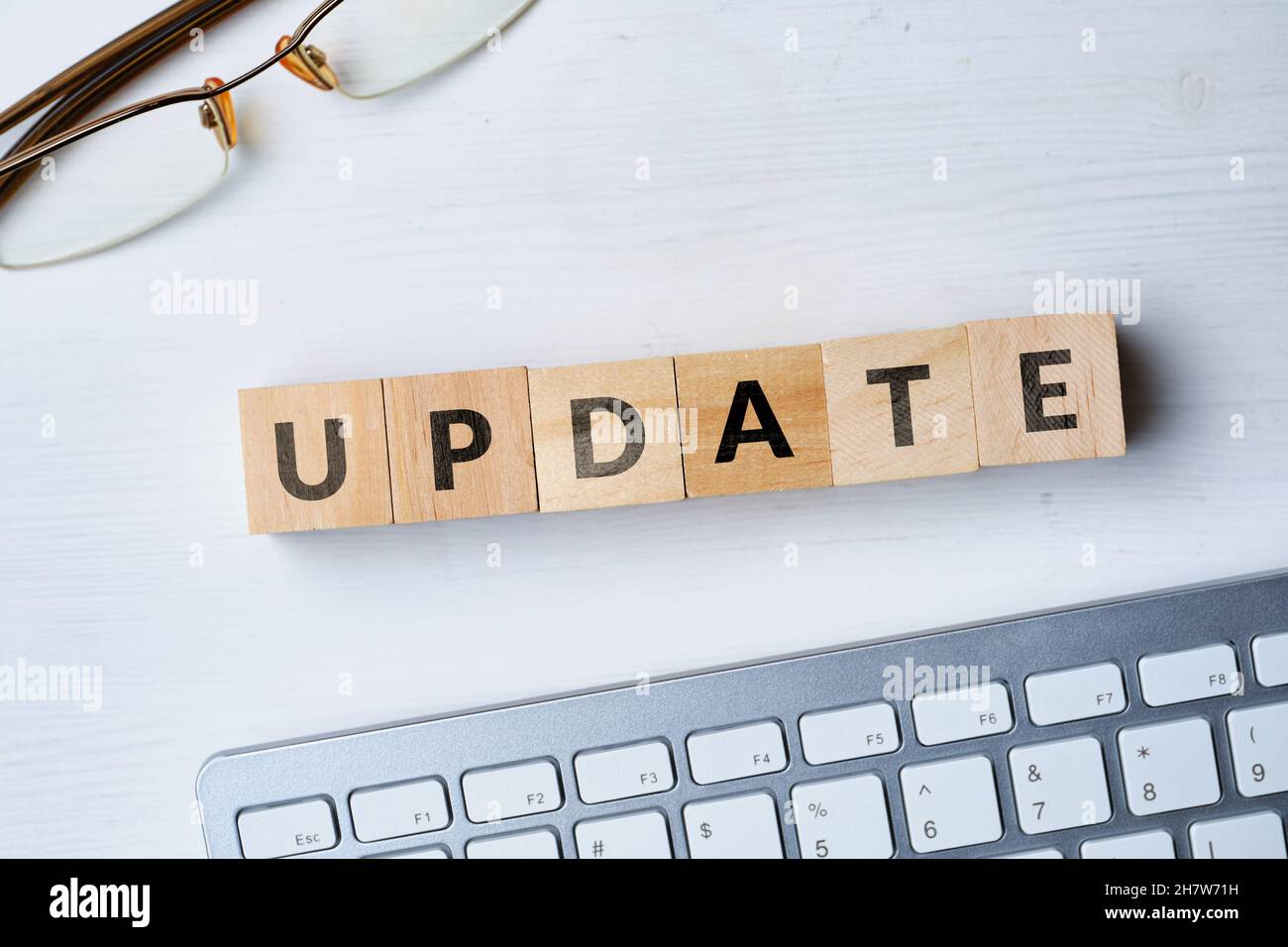 The concept of software update written on wooden cubes next to the keyboard Stock Photo