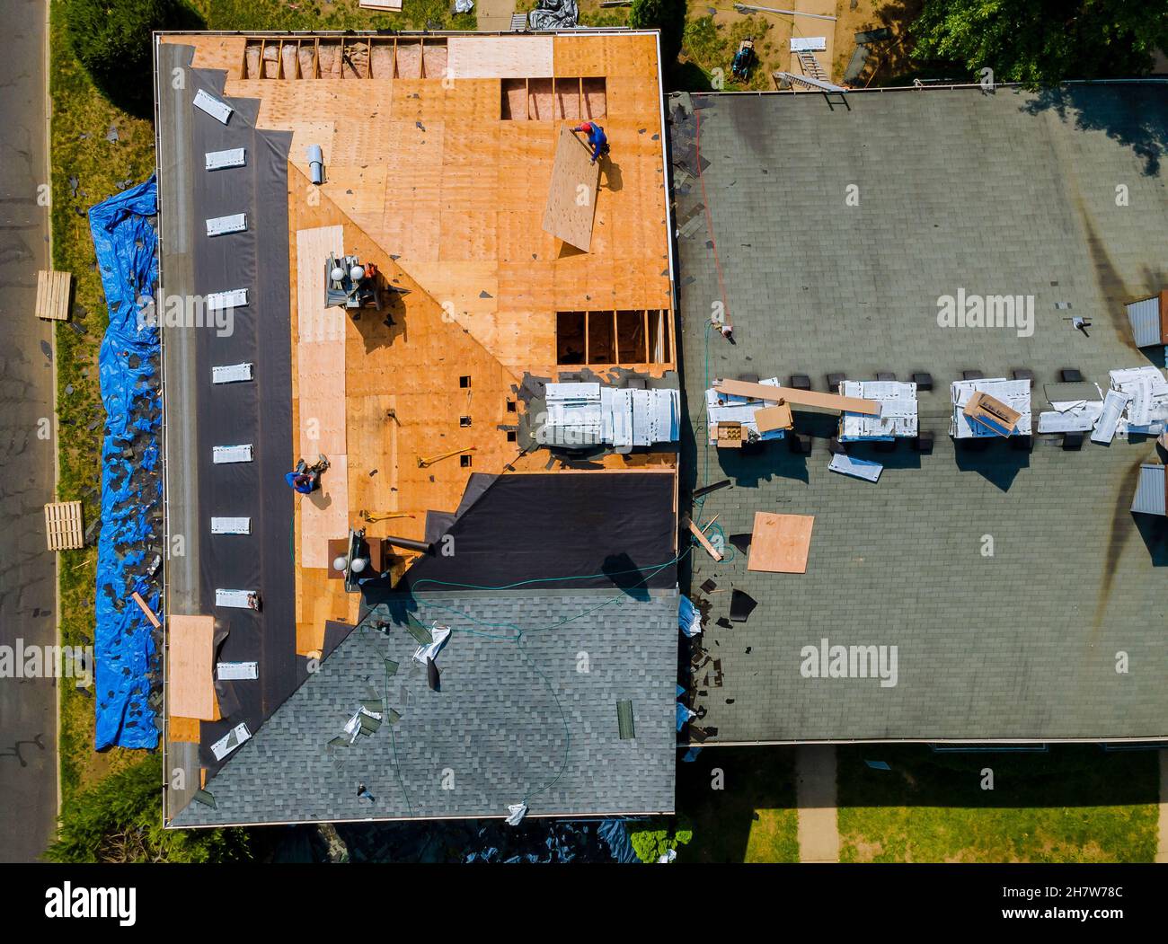 Construction worker on renovation roof the house installed new shingles Stock Photo