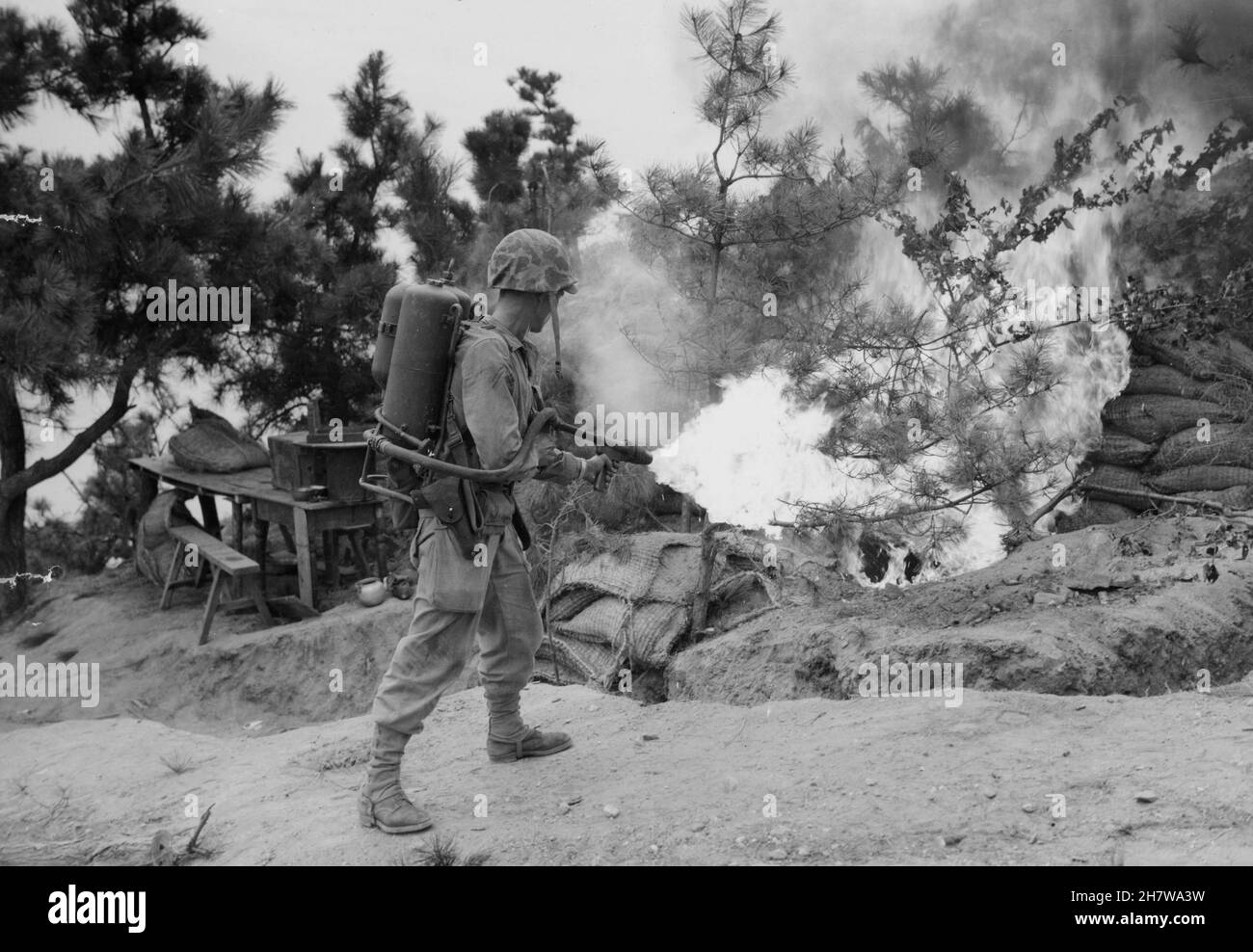 WOLMI ISLAND, KOREA - September 1950 - A US Marine uses a flamethrower to clear a bunker on Wolmi Island before pushing on to Inchon during the Korean Stock Photo