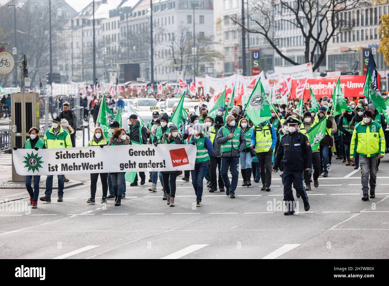 Munich, Germany. 25th Nov, 2021. Demonstration participants hold a banner with the inscription 'GdP - Sicherheit ist MehrWert!' during the demonstration procession of the police union, Verdi and the industrial union Bauen- Agrar-Umwelt (IG Bau AU) from the Theresienwiese to the final rally at the Ministry of Finance. Fair goes differently! - Verdi' in front of it. Credit: Matthias Balk/dpa/Alamy Live News Stock Photo