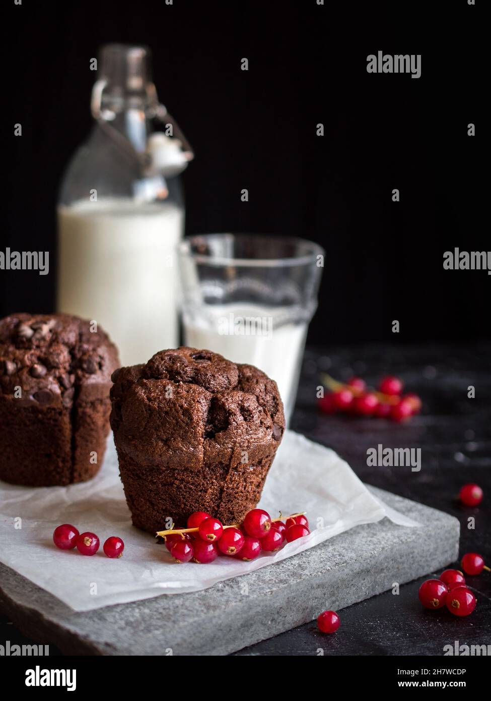 Chocolate muffins, red currants and fresh milk. Beautiful food, Christmas, holiday, birthday, special occasions Stock Photo
