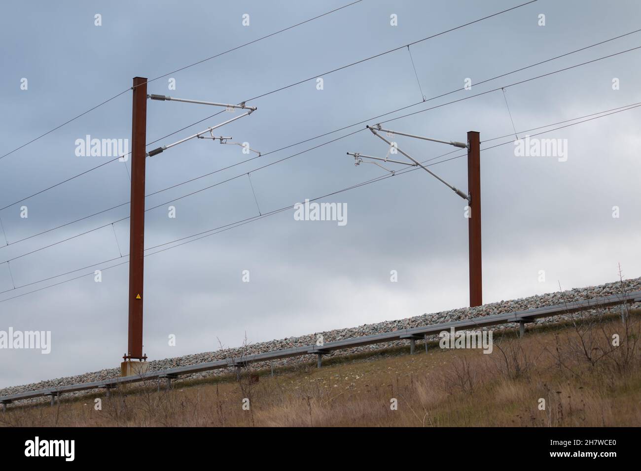 Overhead live electric railway train power supply Stock Photo