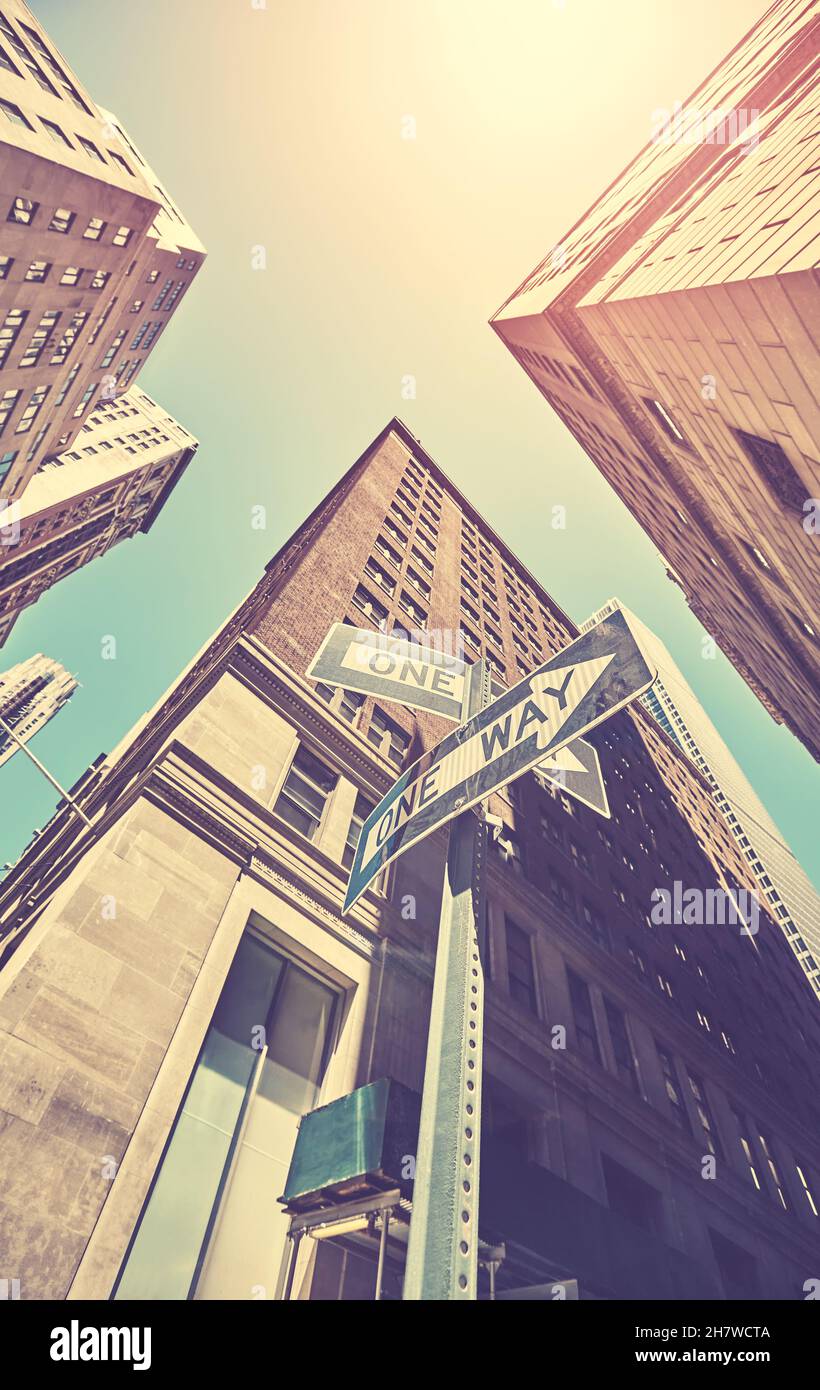 Looking up at One Way road signs in Manhattan, color toning applied, New York City, USA. Stock Photo