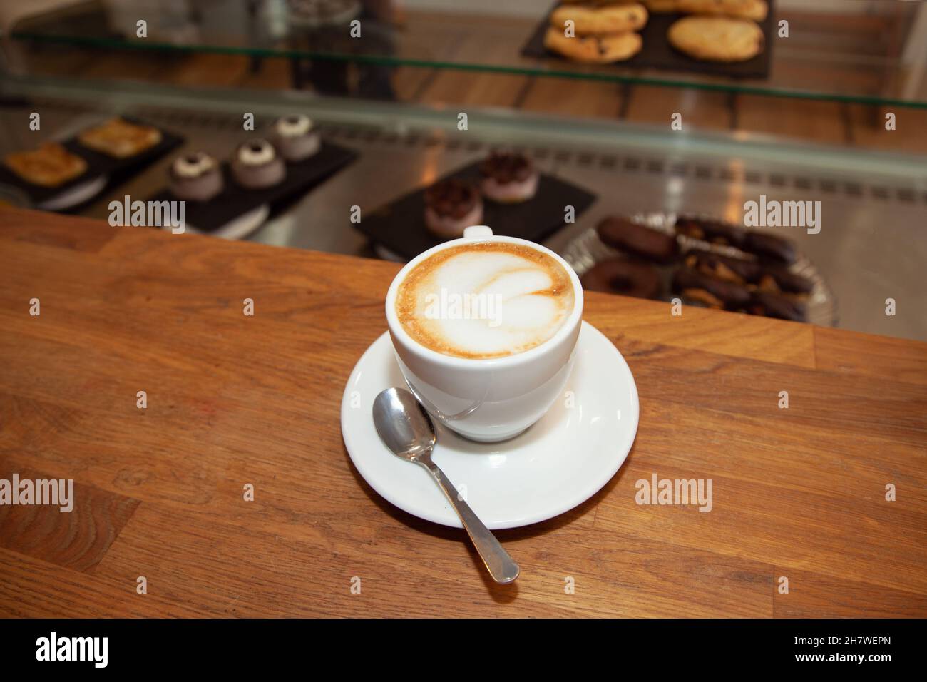 Cafe design. Coffee with cream. Foam coffee. Buns showcase. pastries