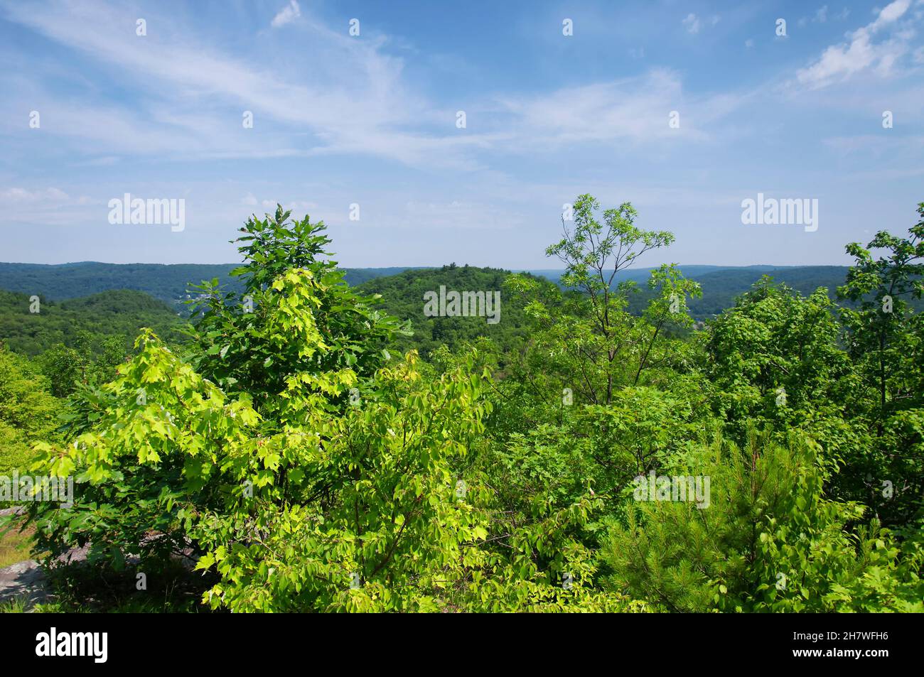 A landscape view of the surrounding hills at the summit of mount tom in wwashington Depot, litchfield county connecticut on a sunny blue sky day. Stock Photo