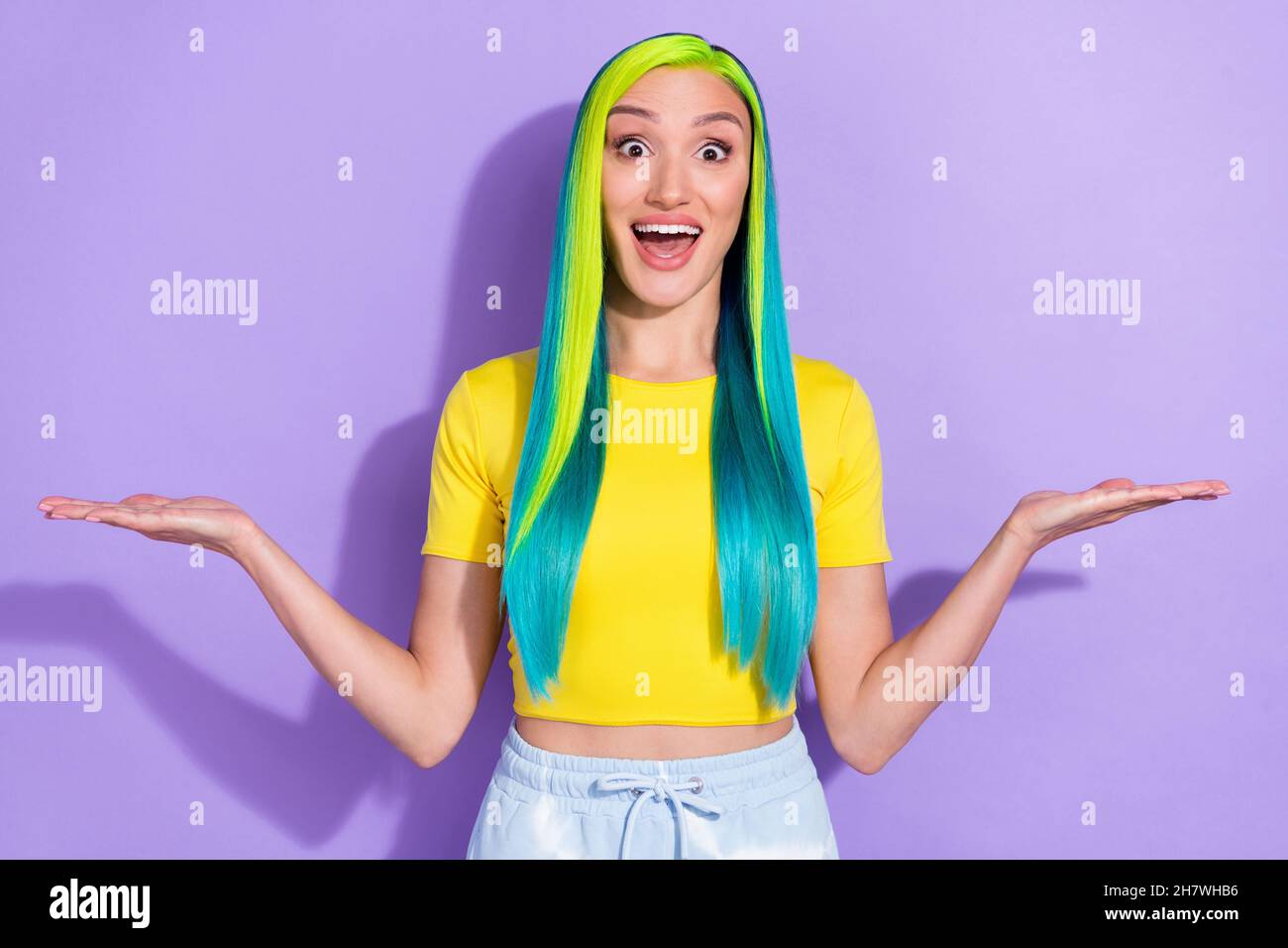 Portrait of beautiful amazed girl advertise product compare products vs ...