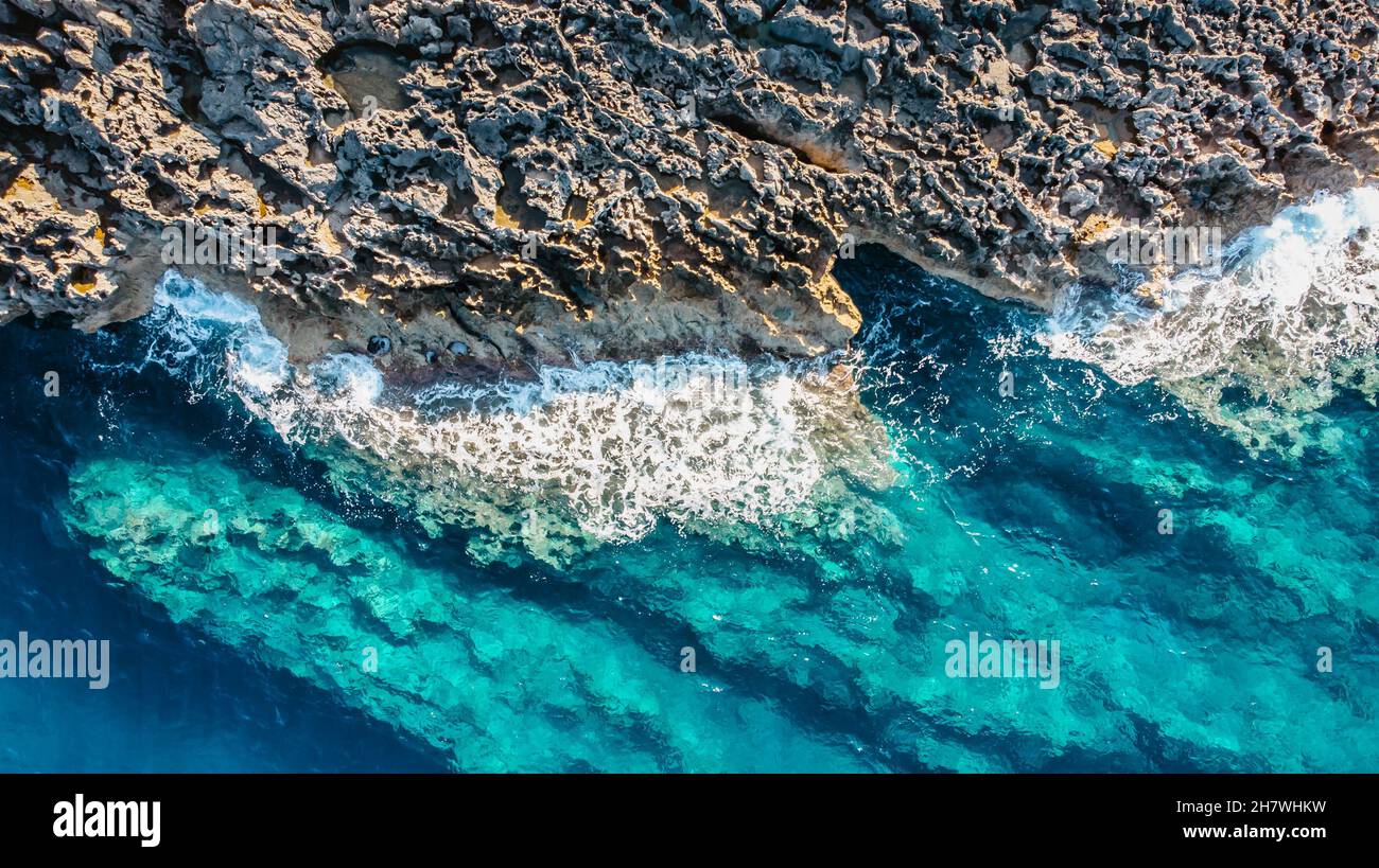 Aerial view of rocky seashore,Malta.Turquoise clear water of Mediterranean Sea.Holiday travel background copy space.Summer vacation scene.Power Stock Photo