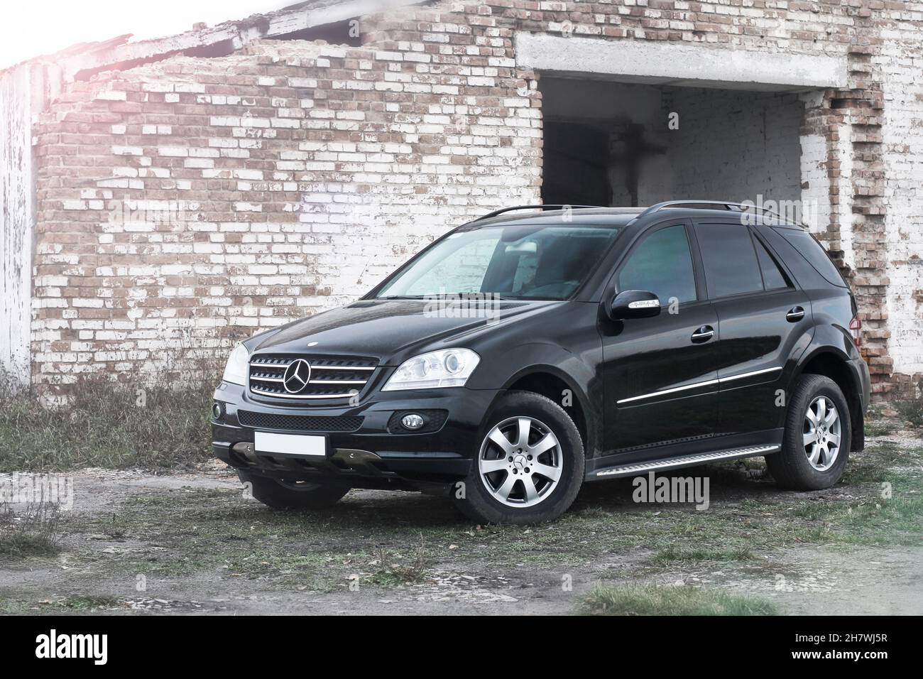 Popelnya, Ukraine - April 10, 2014. Mercedes-Benz ML-Class against the background of a destroyed building Stock Photo