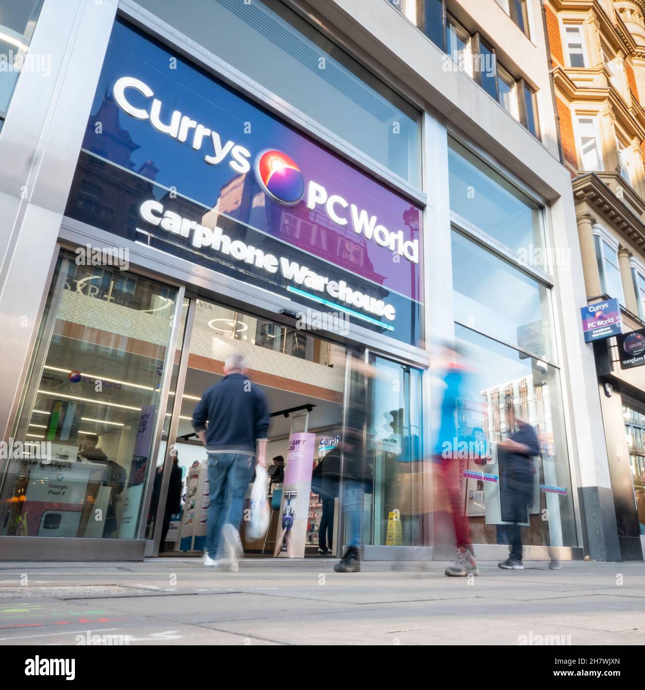 Currys PC World shop, Oxford Street, London. Abstract blur of shoppers passing the high street electrical store on London's busy shopping district. Stock Photo