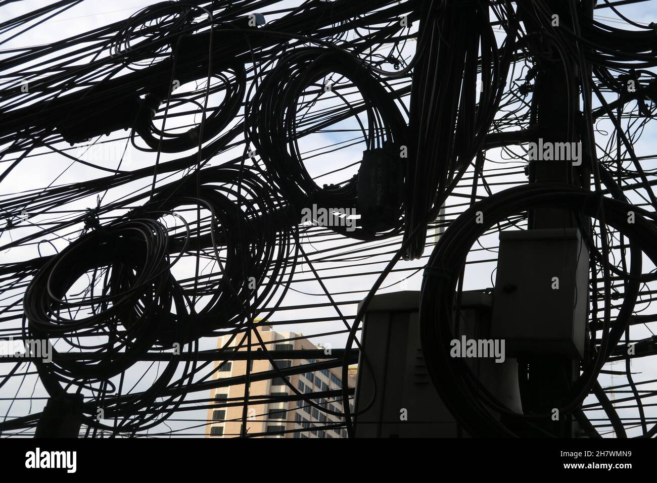 A tangle of overhead cables, Bangkok, Thailand Stock Photo