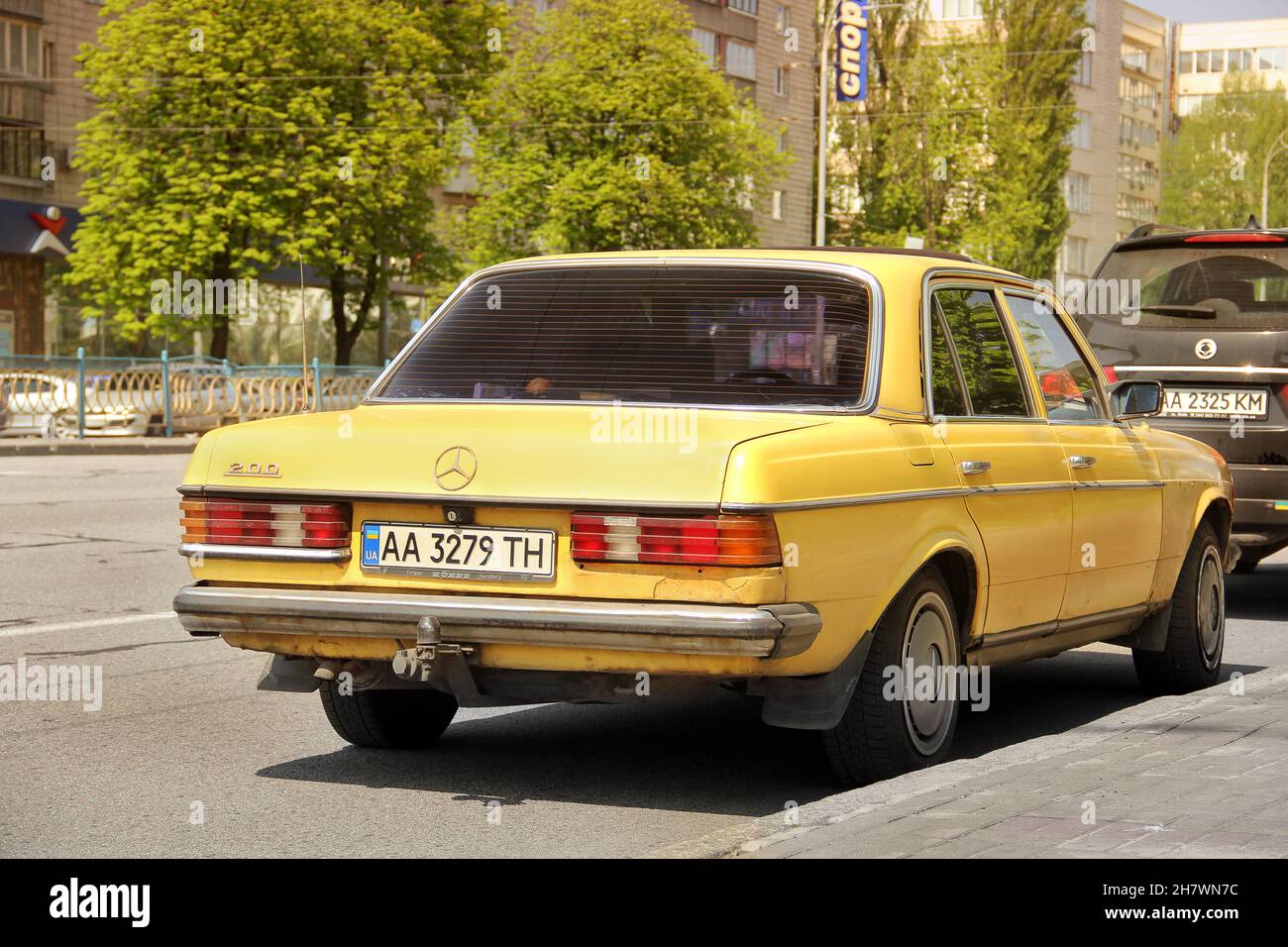 Kiev, Ukraine - May 3, 2019: Yellow old Mercedes E Class in the city Stock Photo