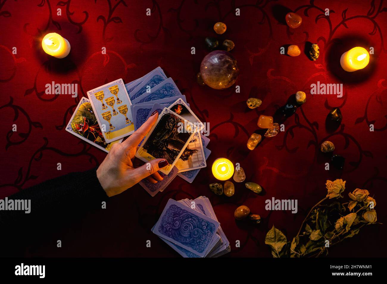 Minsk, Belarus - November 2021: the fortuneteller holds the Death tarot card in his hand. Photo of the layout on the Tarot cards. Stock Photo