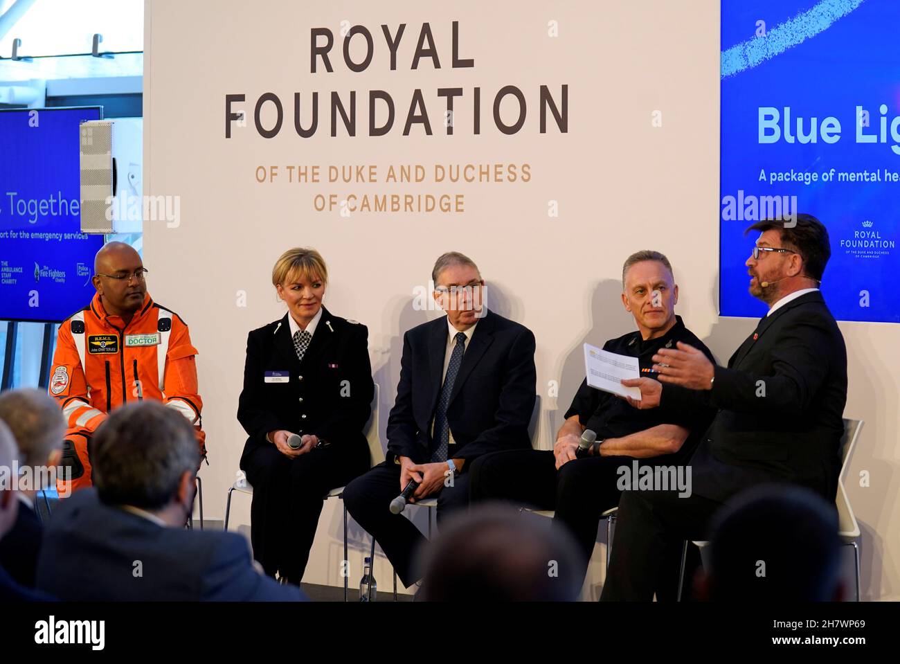 Dr John Chatterjee of the London Air Ambulance, Una Jennings from Cheshire Police, Roger Watson from East Midlands Ambulance Service and Martin Blunden from the Scottish Fire and Rescue Service chat with Nick Knowles on stage during the Royal Foundation's Emergency Services Mental Health Symposium in London, Britain November 25, 2021. Andrew Matthews/Pool via REUTERS Stock Photo
