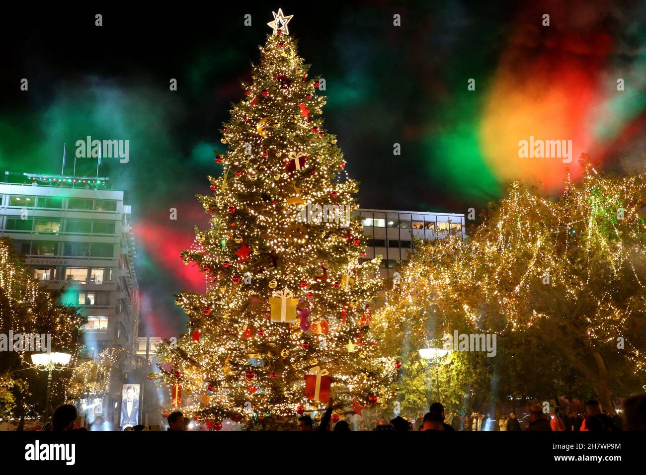 People watch the lighting of the Christmas tree at Syntagma square in ...