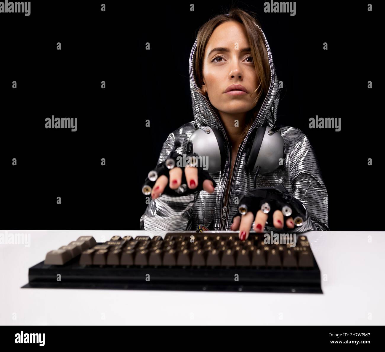 Woman with silver costume typing on keyboard Stock Photo - Alamy