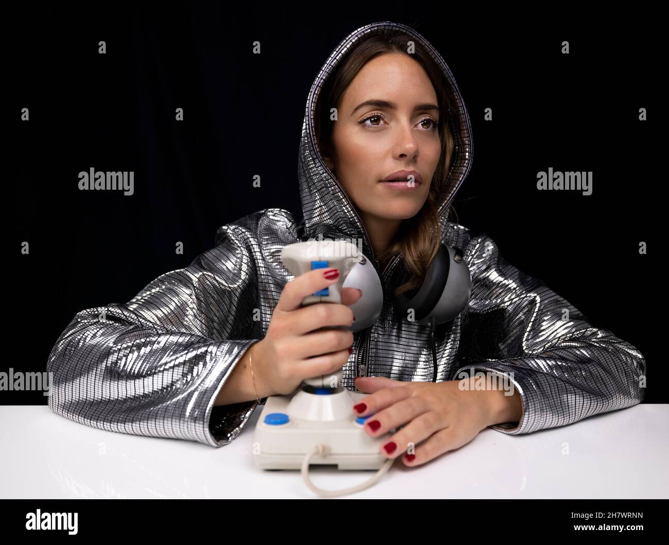 Woman with silver costume and computer joystick Stock Photo