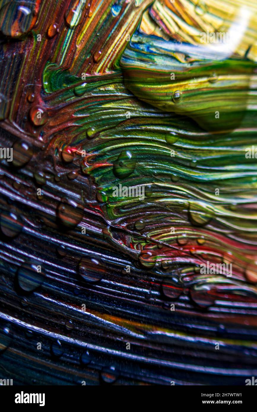 Colorful multicolored paints are covered with water drops. Multicolor ...