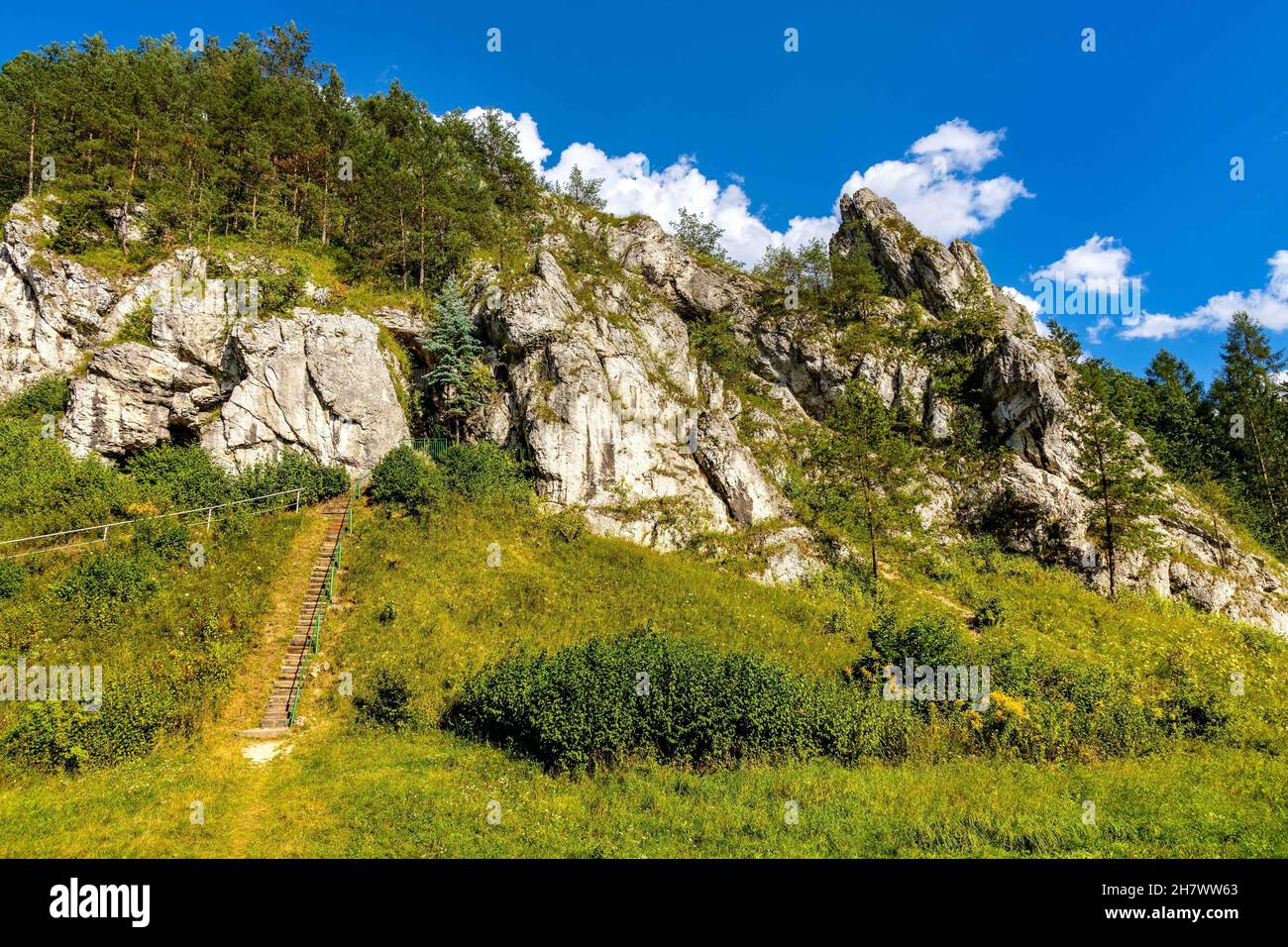 Zabi Kon and Mnich rock with path to Holy Mary cave shrine in Kobylanska Valley within Jura Krakowsko-Czestochowska upland near Cracow in Lesser Polan Stock Photo