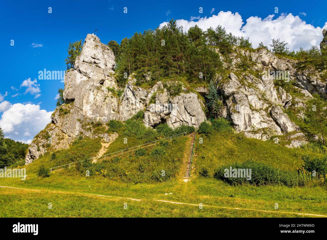 Zabi Kon and Mnich rock with path to Holy Mary cave shrine in Kobylanska Valley within Jura Krakowsko-Czestochowska upland near Cracow in Lesser Polan Stock Photo