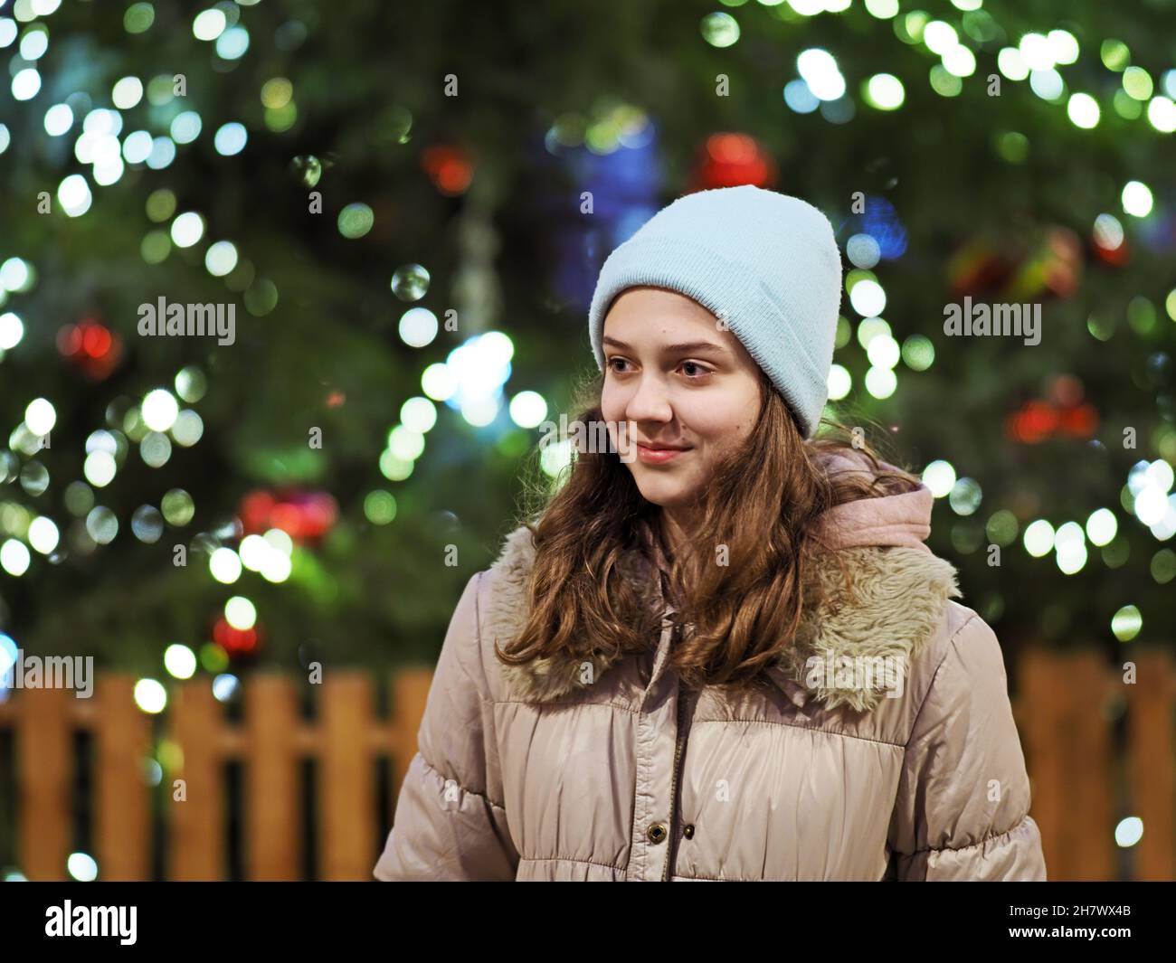 Authentic tenage girl in front of a Christmas tree Stock Photo