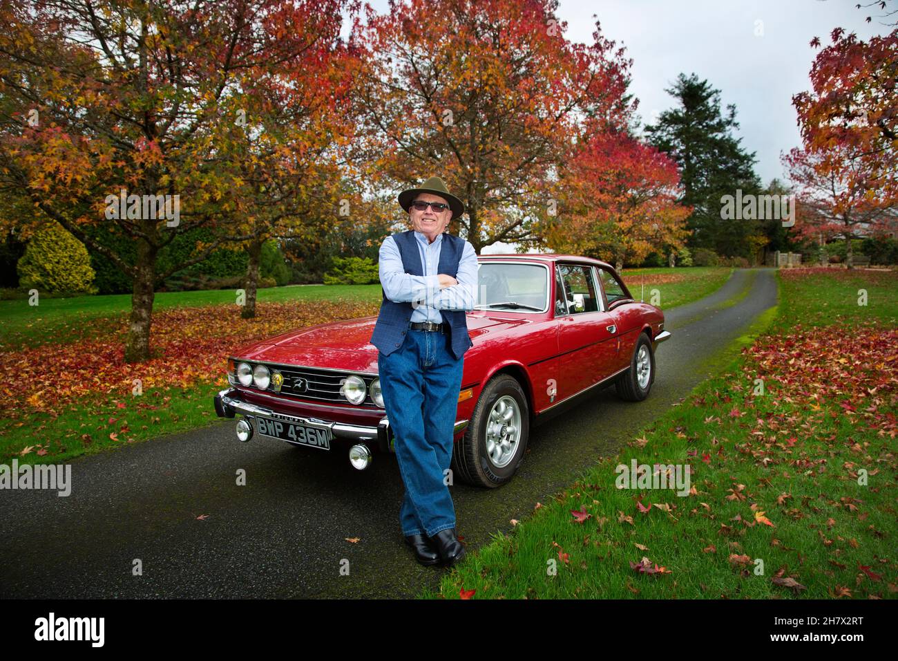 A red Triumph Stag V8 with it's proud owner Stock Photo