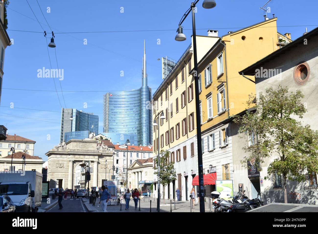 Milan, Italy - September 25, 2015: Sunny View from Corso Garibaldi Busy Street to the Ancient Porta Garibaldi City Gate and the Unicredit Skyscraper. Stock Photo