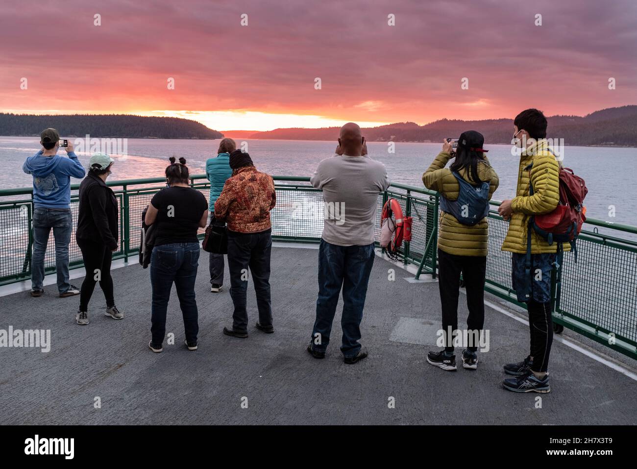 WA20434-00....WASHINGTON - Passangers watching  the sunset on a Washington State Ferry bound for Anacortes, San Juan Islands group. Stock Photo