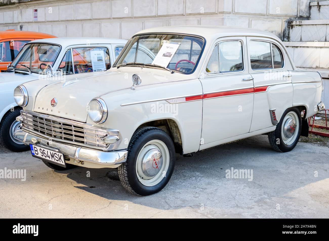Bucharest, Romania, 2 October 2021: One vivid white Moskvitch 403 Russian vintage car produced in year 1964 and parked in a street at an event for vin Stock Photo
