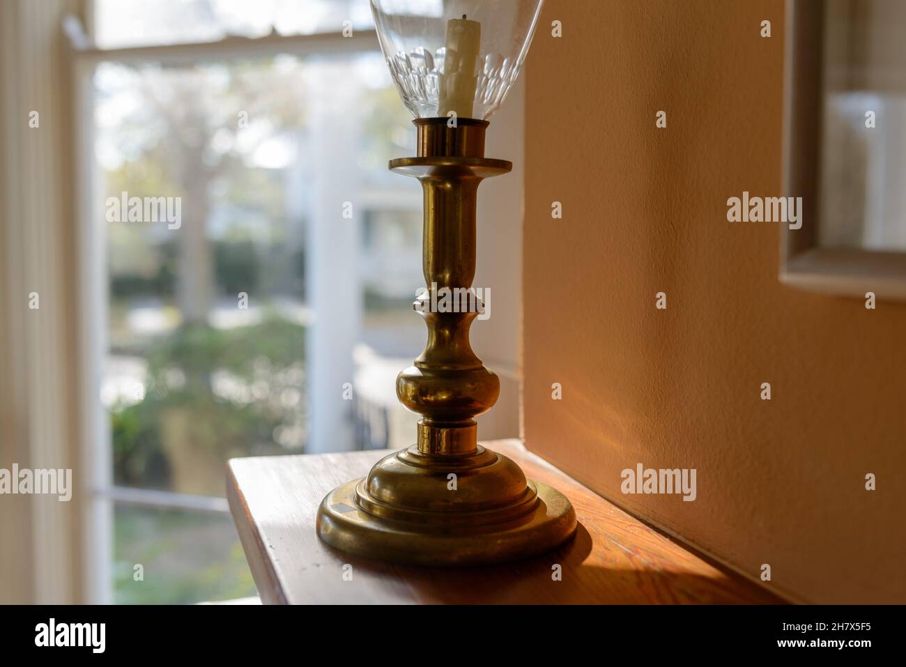 Selective focus of antique brass candlestick on fireplace mantle Stock