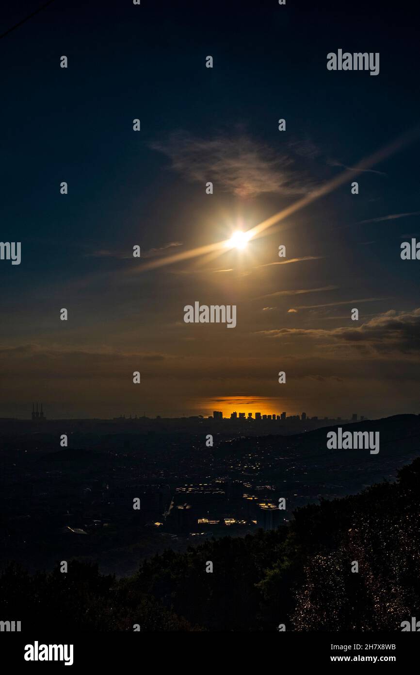 The sun rises over Barcelona and the Mediterranean, early morning ride, October 2021. Stock Photo