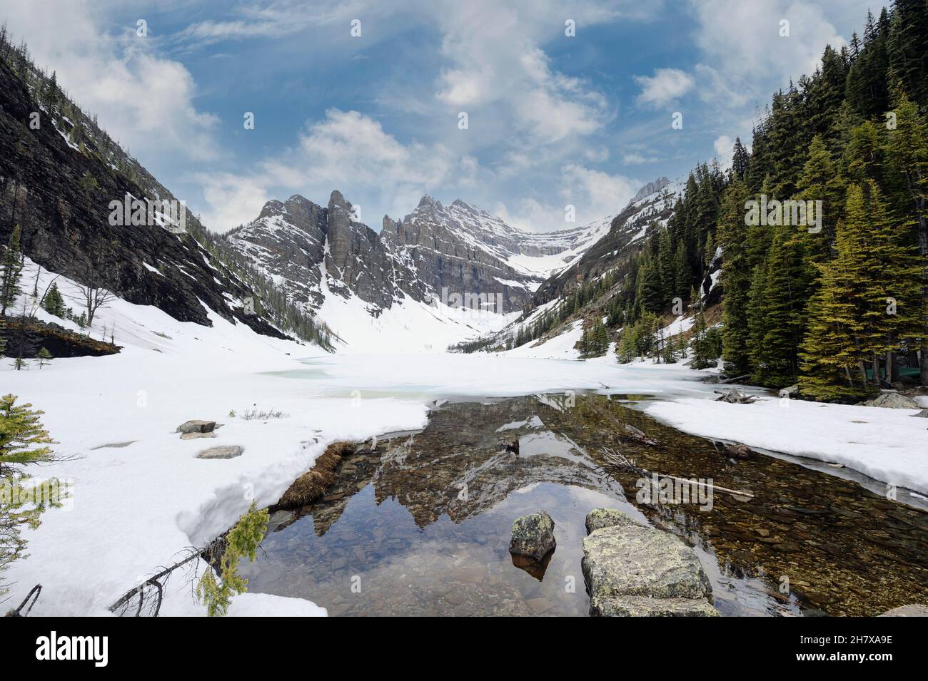 Lake Agnes is a small mountain lake in the Banff National Park in Alberta, Canada. Springtime in the Rockies Stock Photo