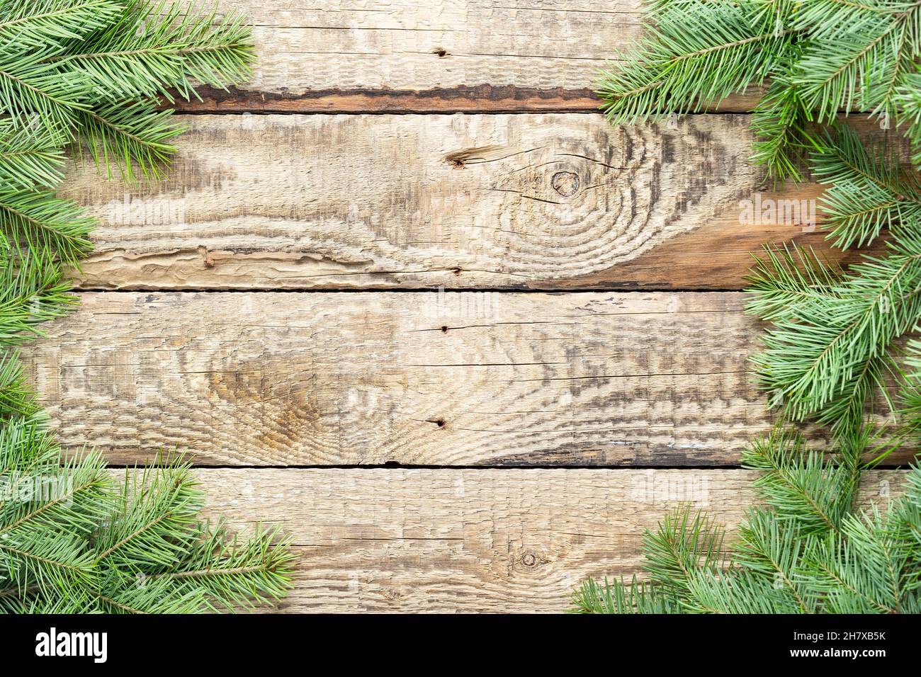Christmas tree green branches on a wooden background. Decorations for Christmas and New Year. Top view, copy space Stock Photo