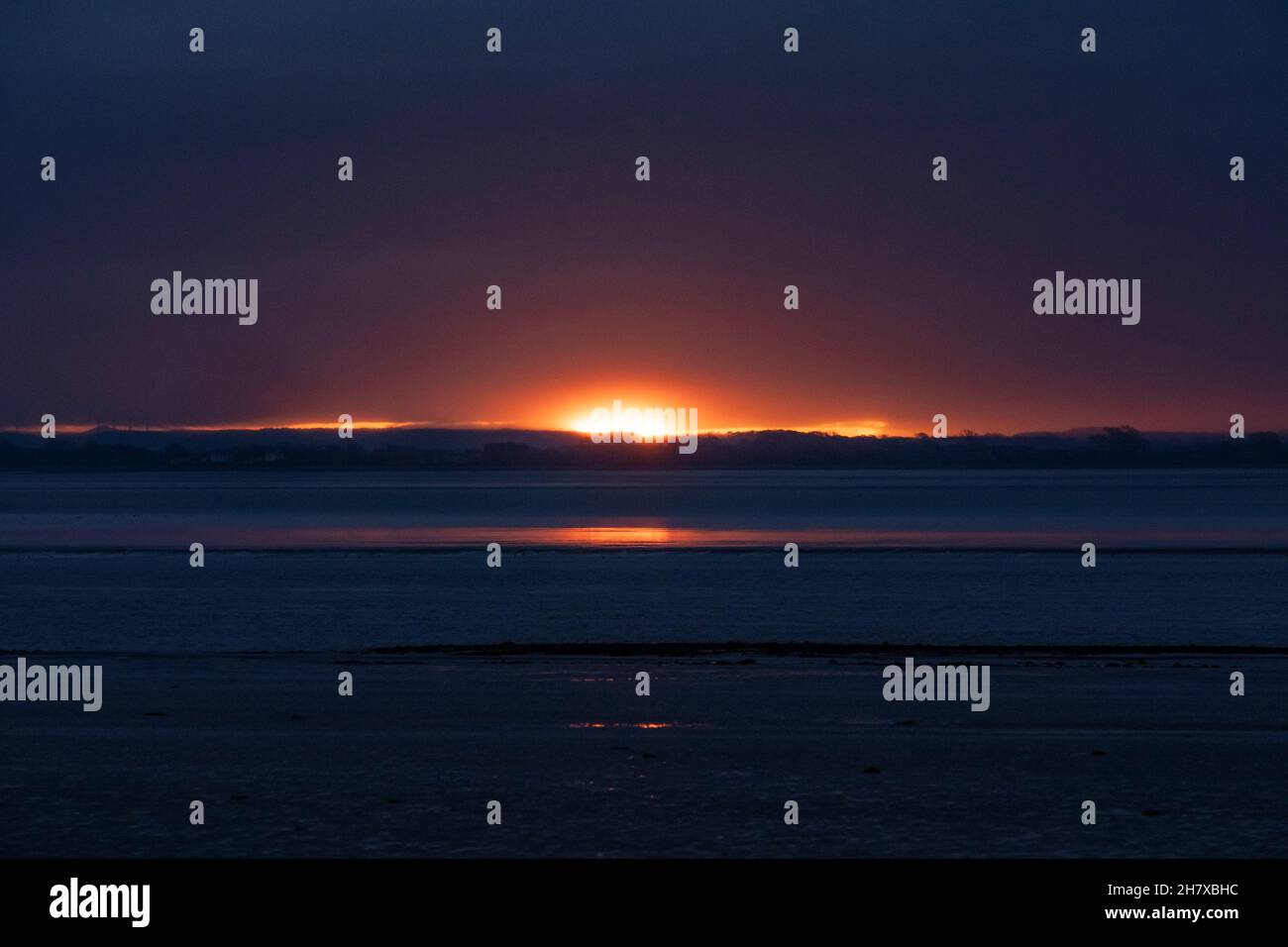 Sunrise over the Solway Firth looking from Scotland towards Cumbria on a winter morning. Stock Photo
