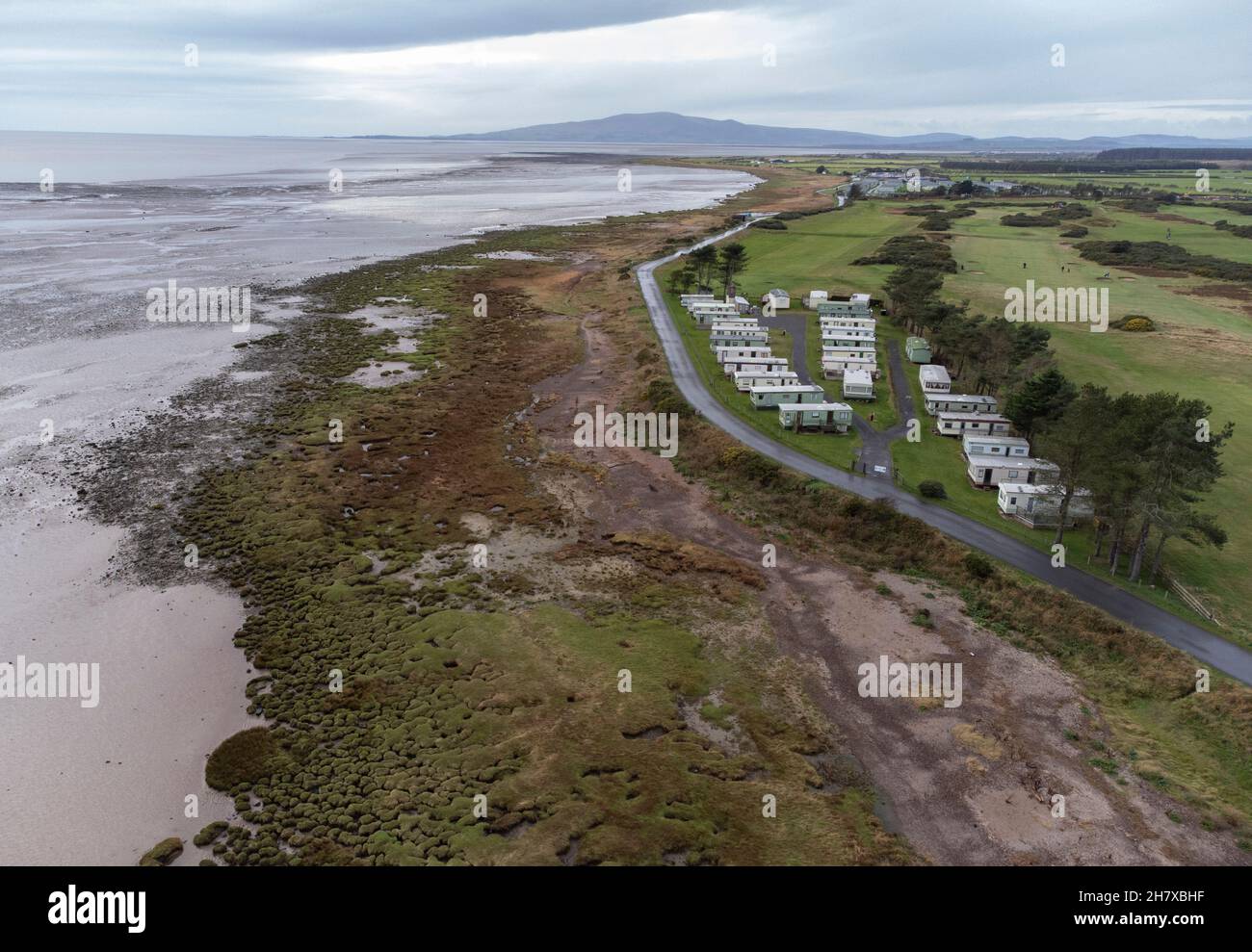 An aerial view of the Solway Firth coast line at Powfoot, Dumfries and Galloway, Scotland showing a coast road and a holiday caravan park. Stock Photo