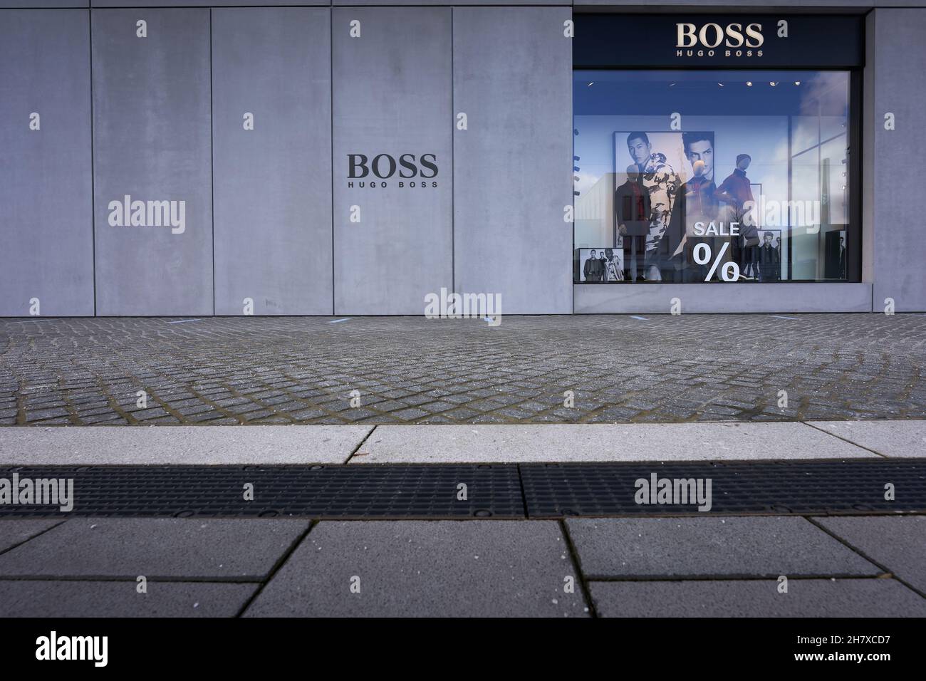 Metzingen, Germany - March 20, 2021: Hugo Boss Outlet store. Shop windows  with mannequin under black facade. Cobblestones in the foreground. Front  vie Stock Photo - Alamy